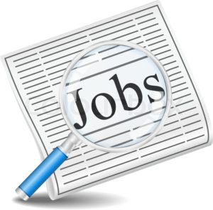 Jobs written on newspaper with magnifying glass